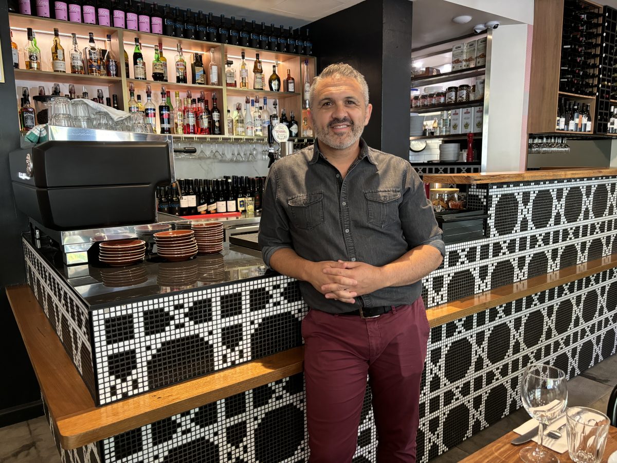 A man standing in front of a bar