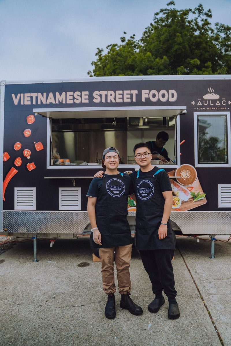 Two men standing in front of a food truck