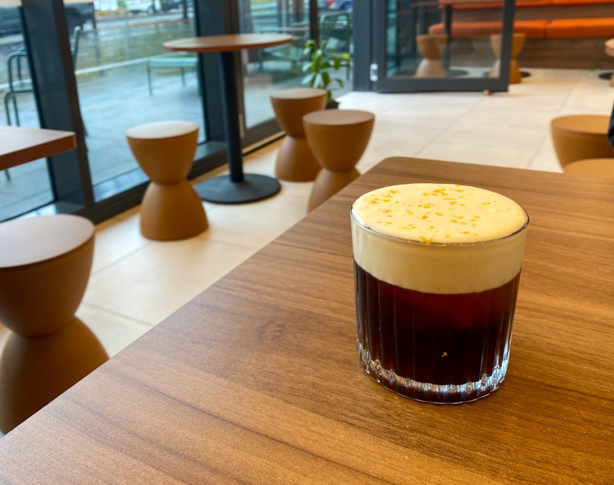 Cup of creamy coffee on table