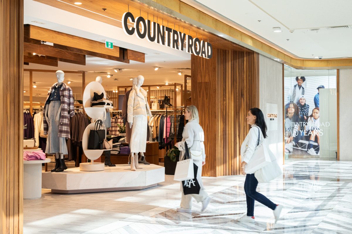 Two ladies walking in to a store