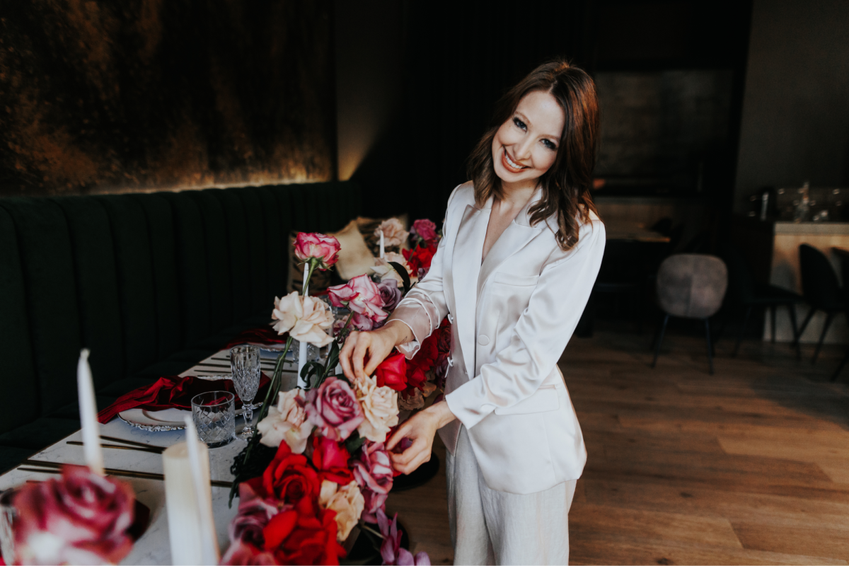 Carissa Webster styling flowers on a table