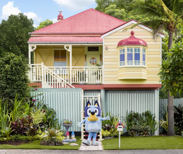 Bluey in front of a reconstruction of the Heeler home