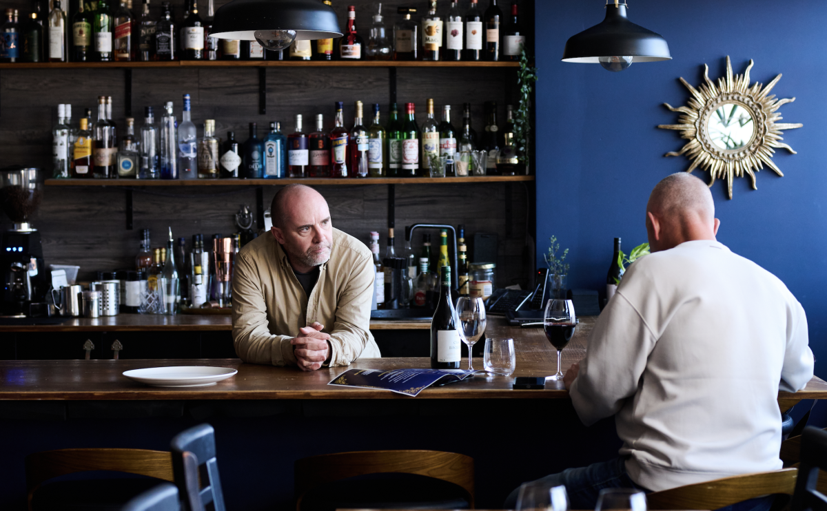 two men at a restaurant bar