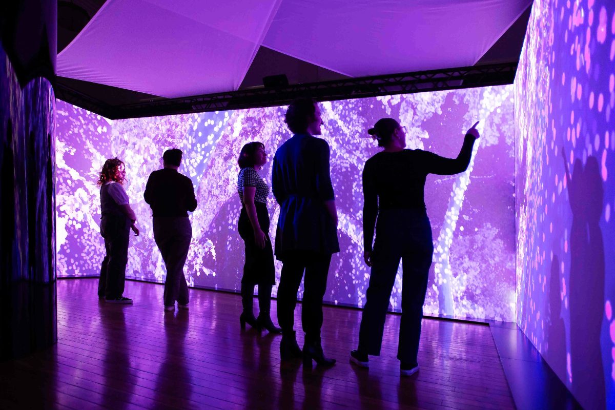 Five people view a purple screen