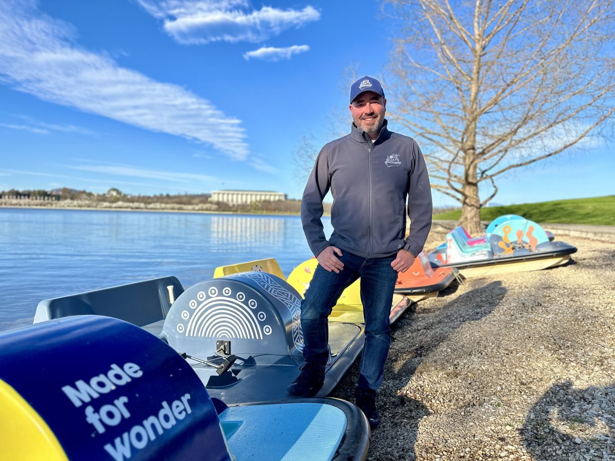 Man standing on paddle boats