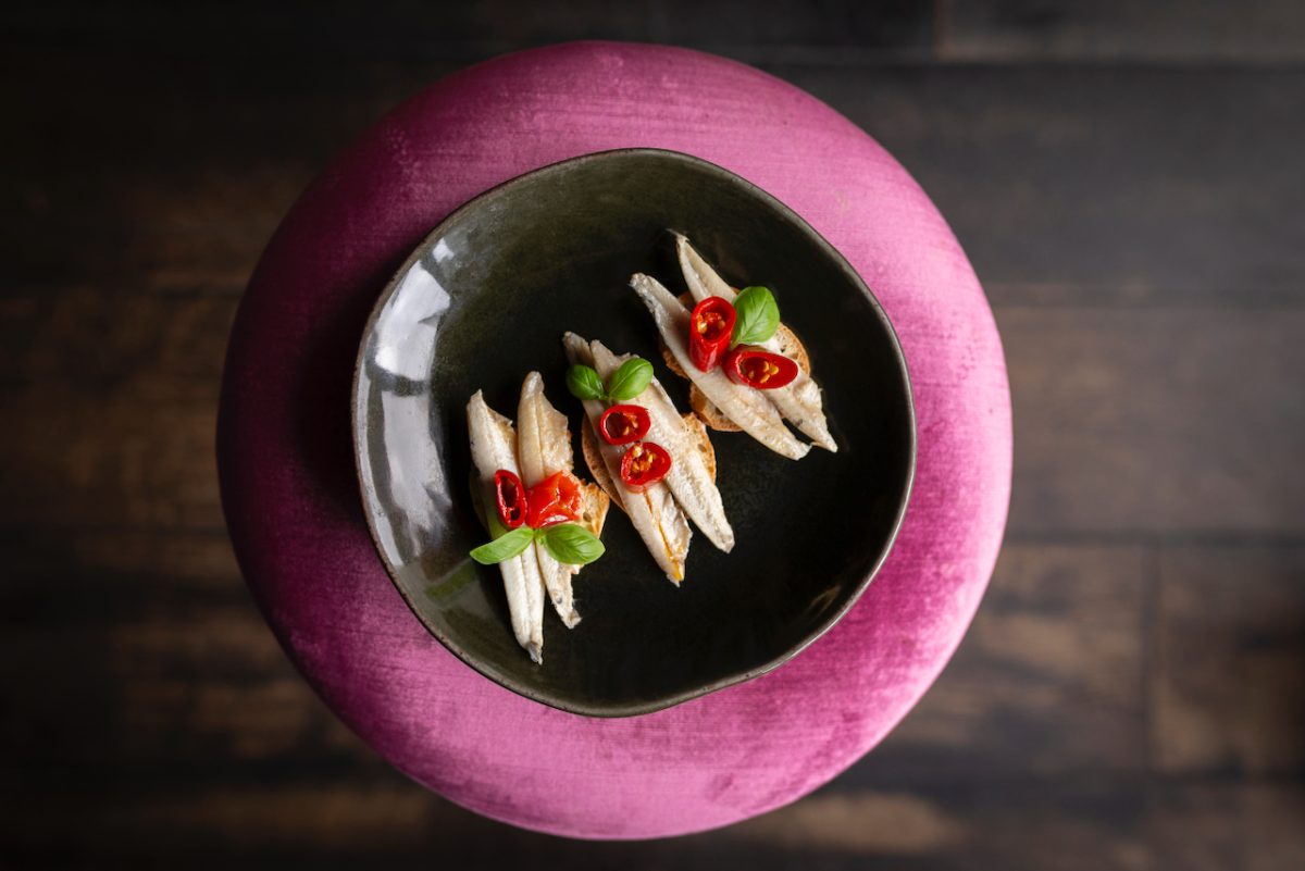 Anchovies on a plate with chilli