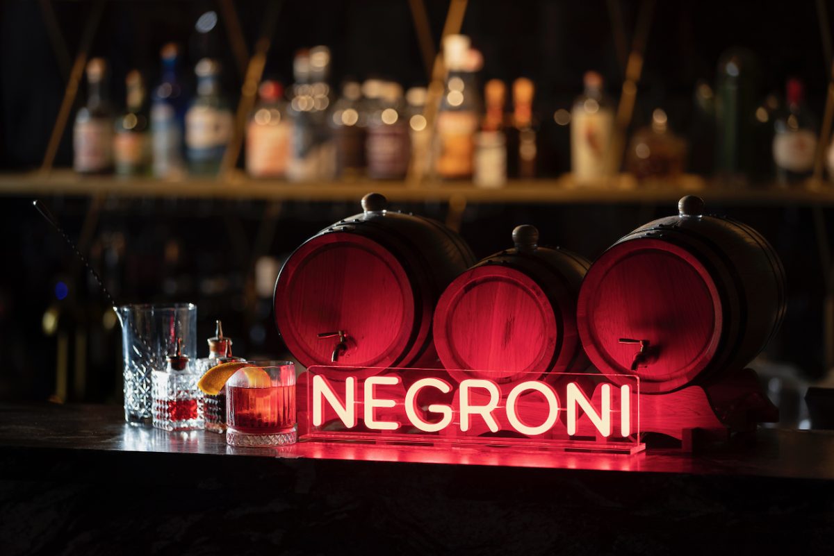 neon red 'Negroni' sign on a bar.