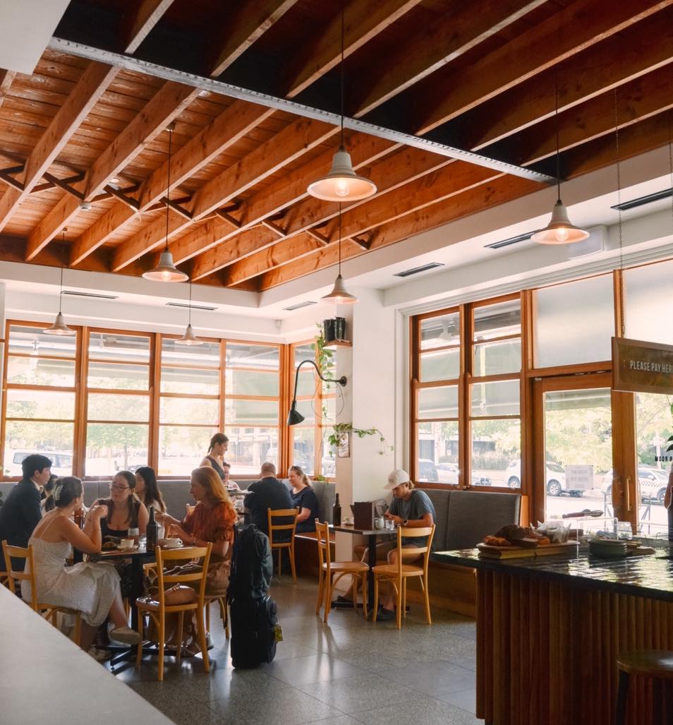 Interior of cafe with wooden beams.