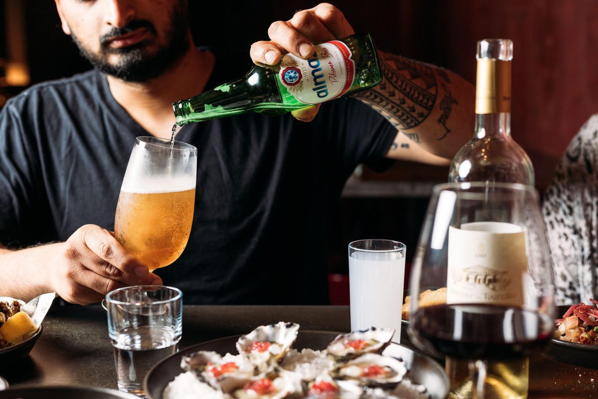 A man pouring a beer at a bar