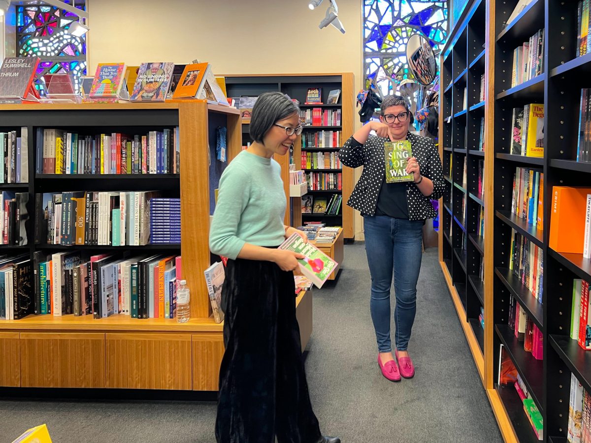 Two people standing in front of books