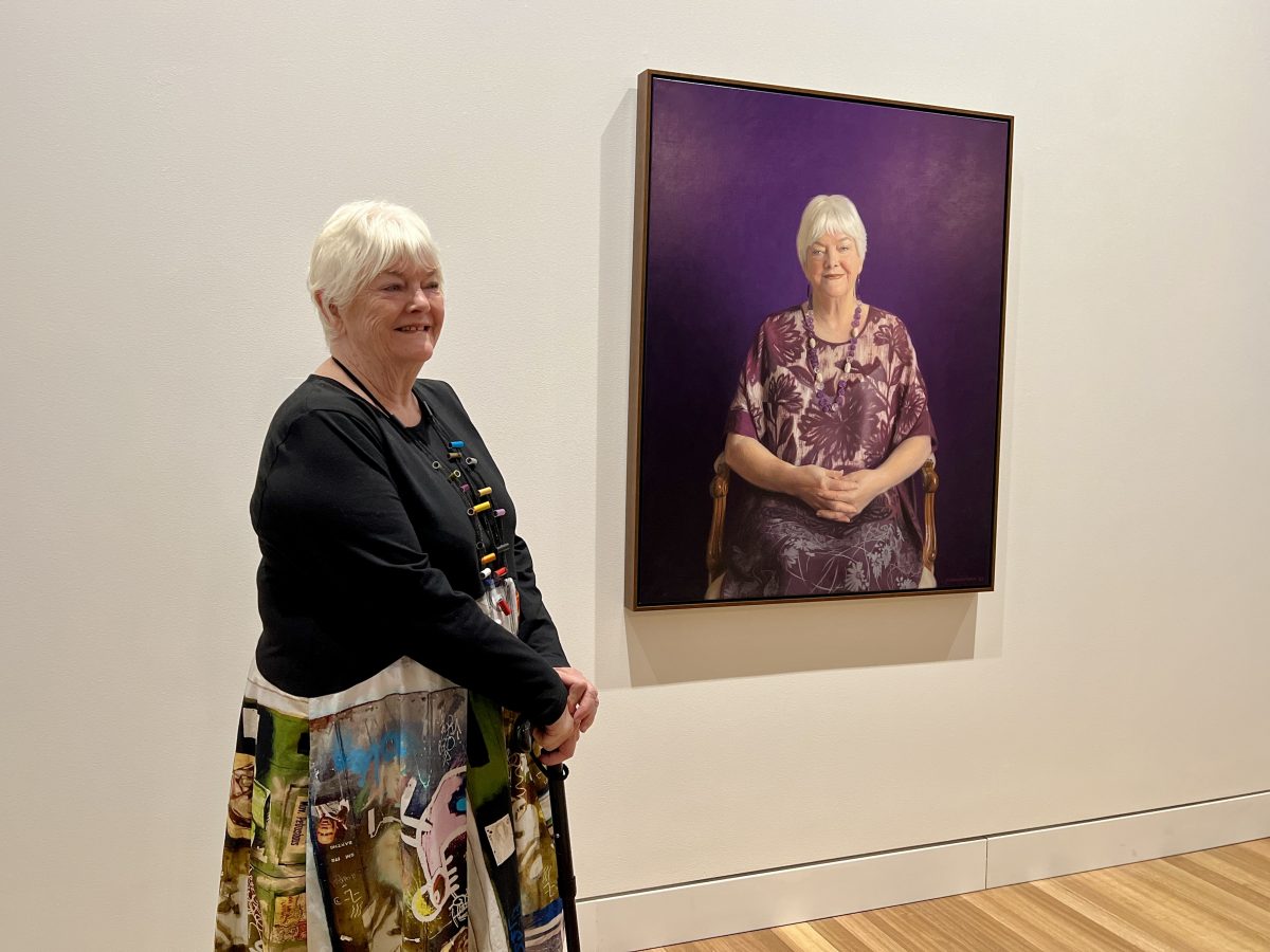 Stephanie Alexander stands next to her portrait.