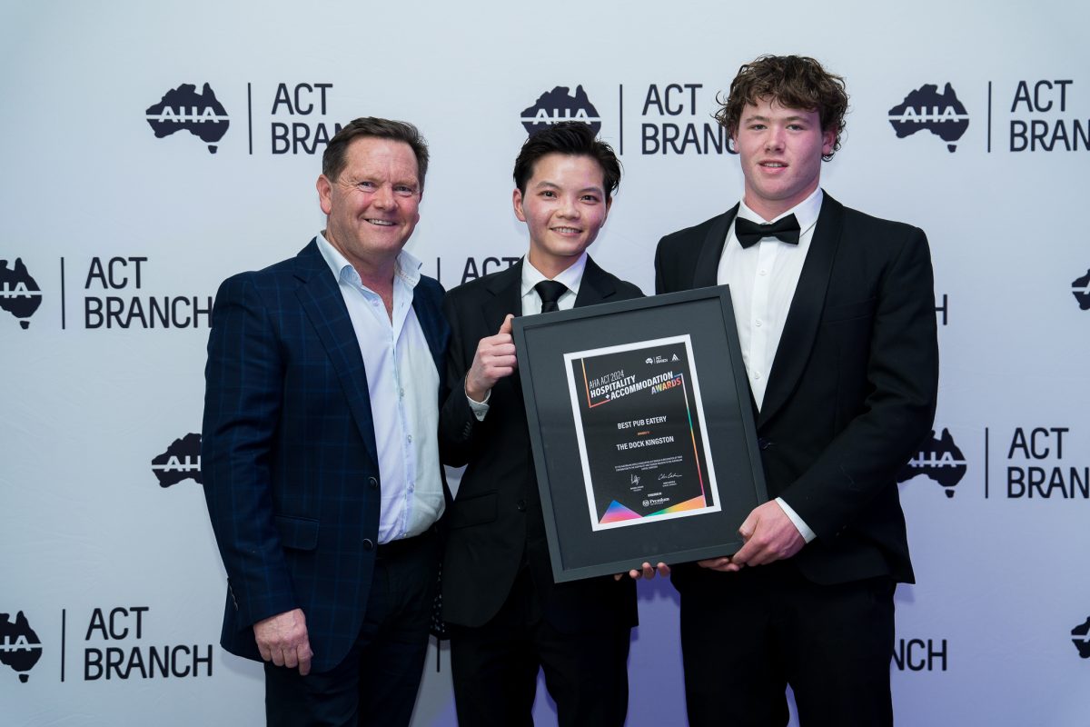 Sean Hugg of Carlton United breweries presents The Dock staff Head Chef Pony Su and Bar Supervisor Oscar Campbell their award for Best Pub Eatery.