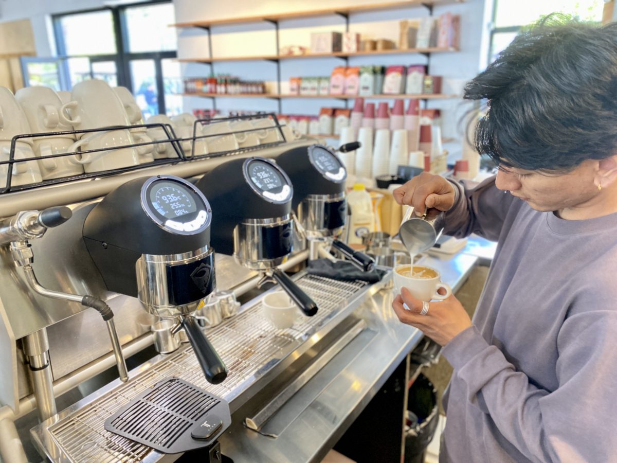 A barista makes a coffee