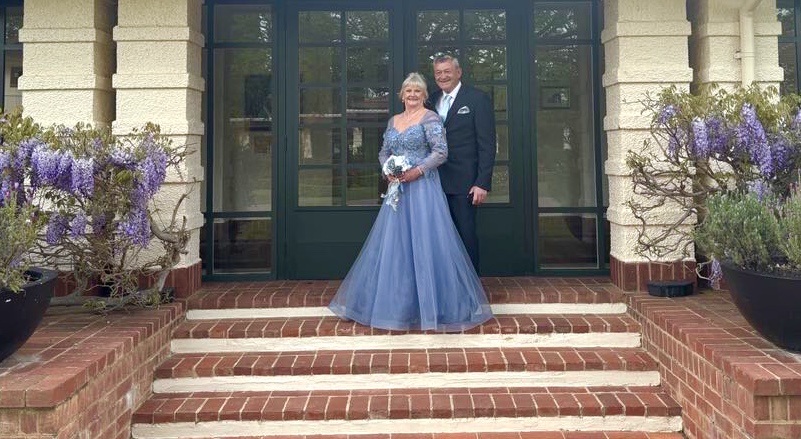 Couple on steps of hotel