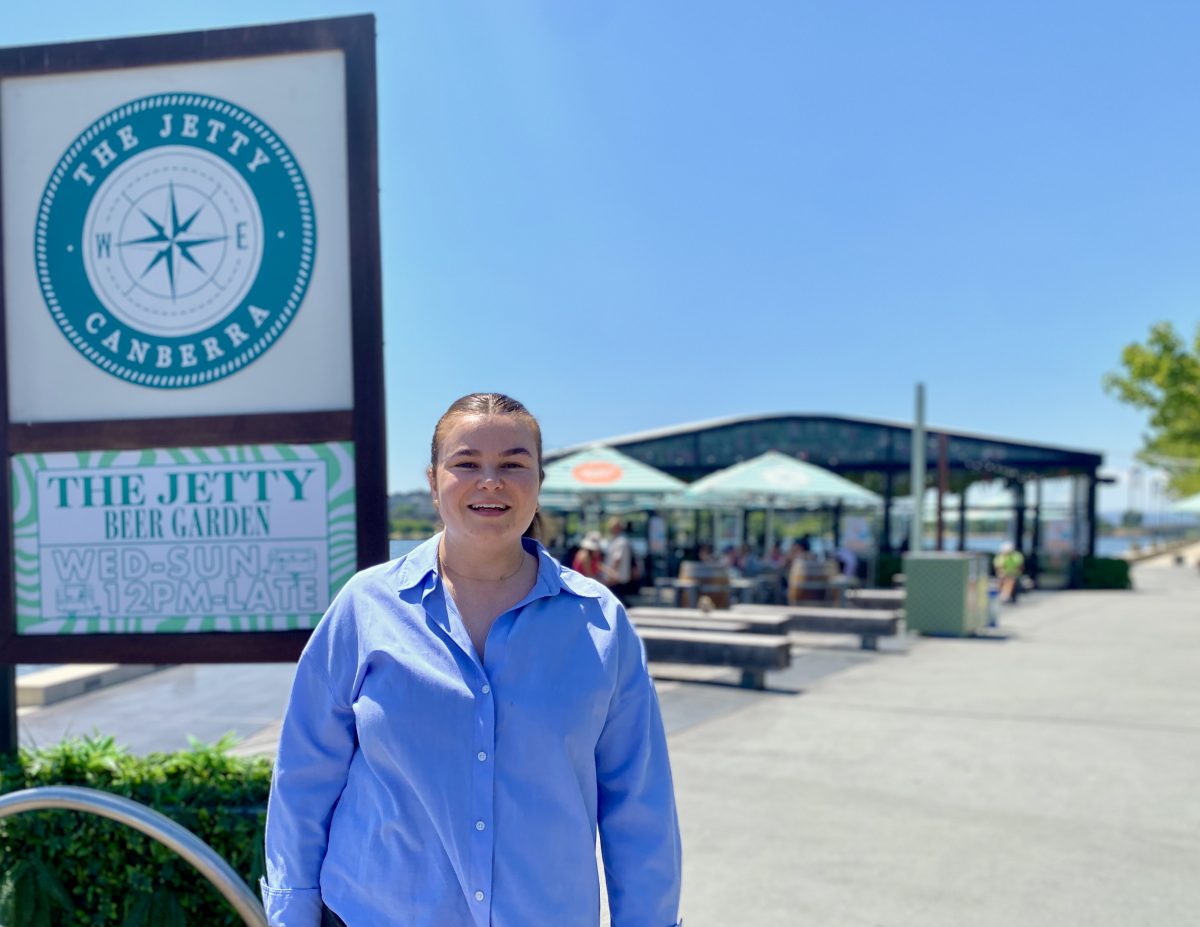 Rena Judd in front of The Jetty sign and restaurant.