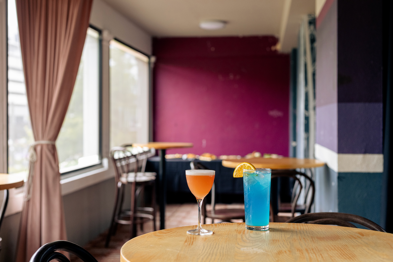 Two retro looking cocktails: one orange and one blue.