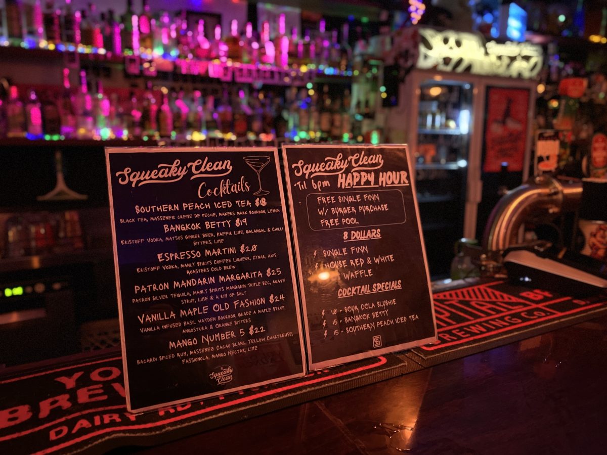 Two small blackboards at a bar with a specials menu