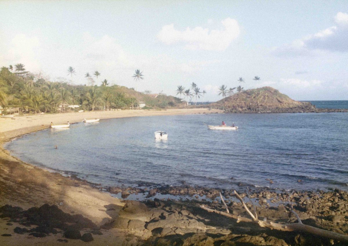 Native village scene with bay and boats