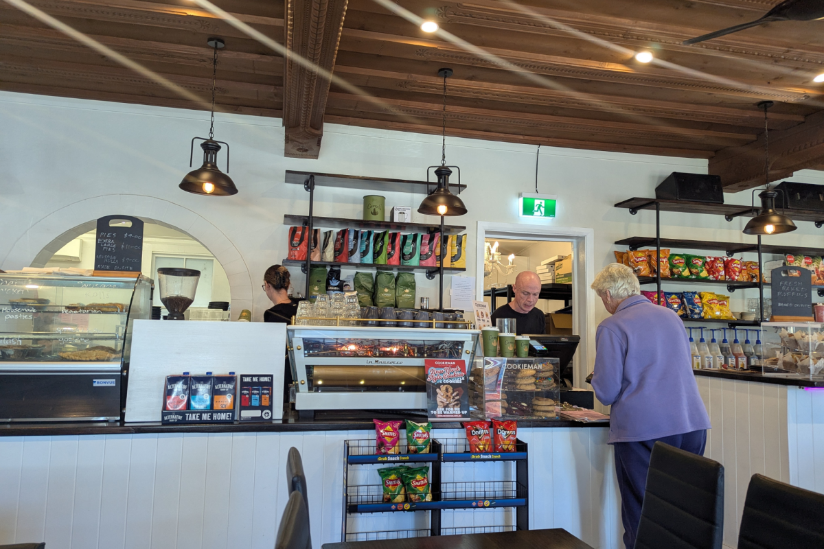 Person being served at cafe counter.