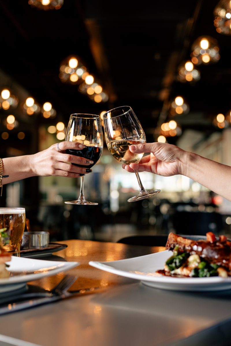 Clink of glasses, one red wine and one white wine