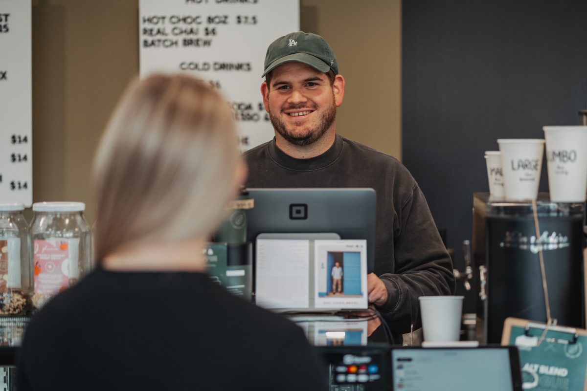Barista Caleb Evans at the checkout