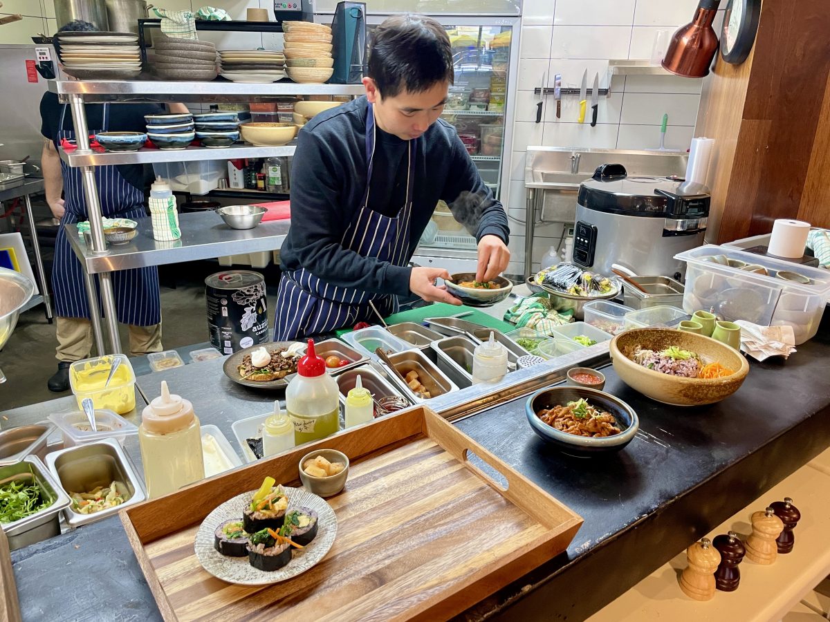 A chef plates up in the kitchen.