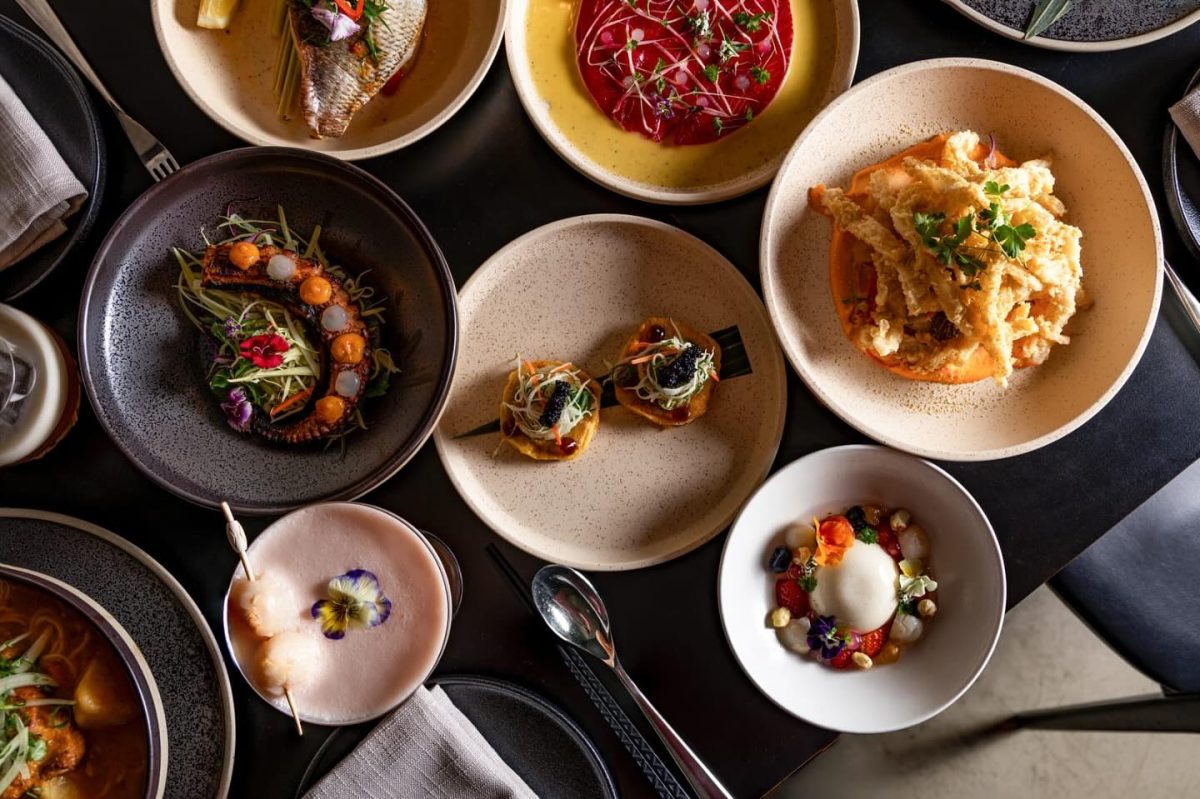 A top-down shot of a table filled with delicious looking food.
