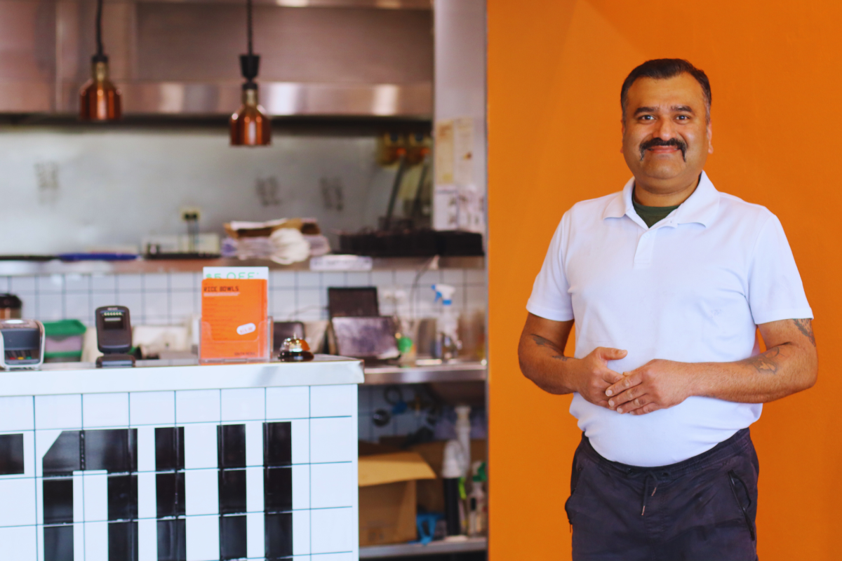 Man standing in front of kitchen.