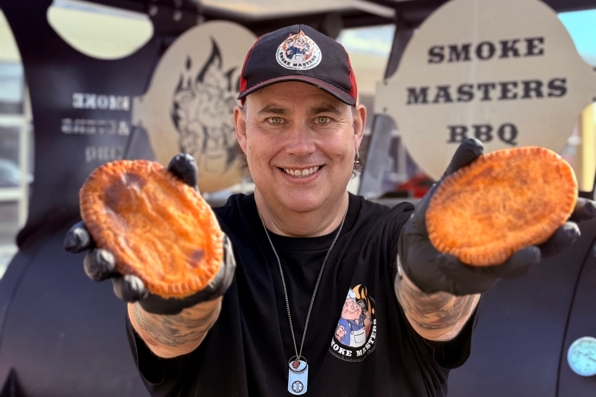 Man holding two pies.
