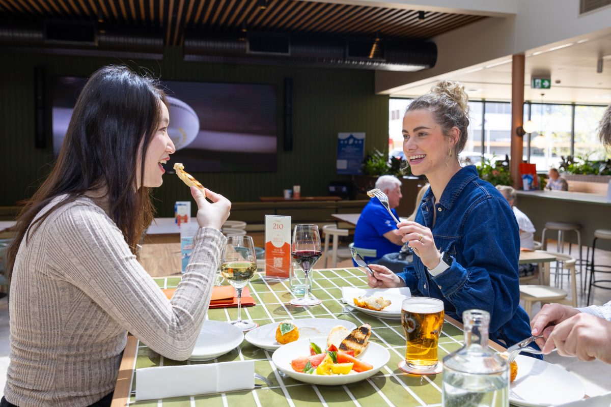 two people eating food in a pub