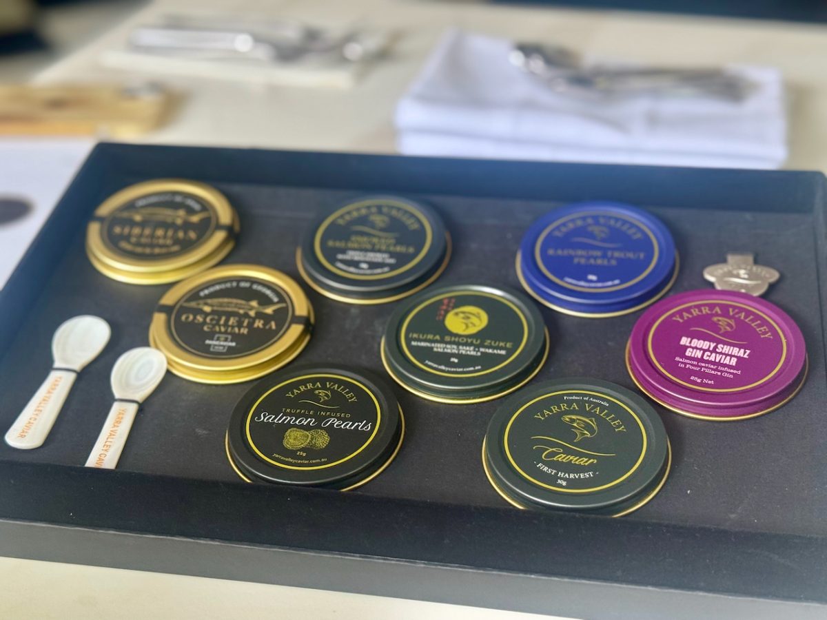 A tray of different Yarra Valley caviar tins, including salmon pearls, Oscietra caviar, and gin infused caviar.