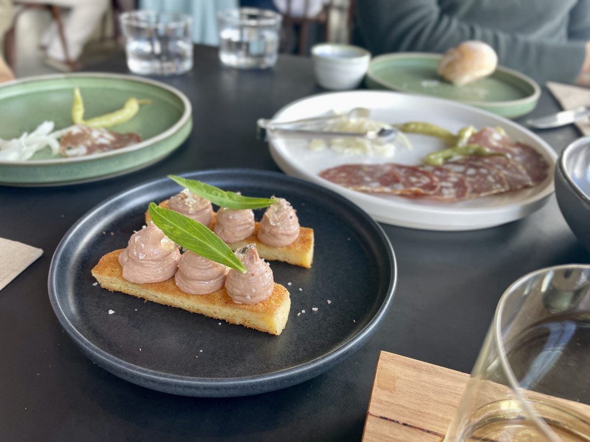 Chicken Liver Pate piped onto bread.