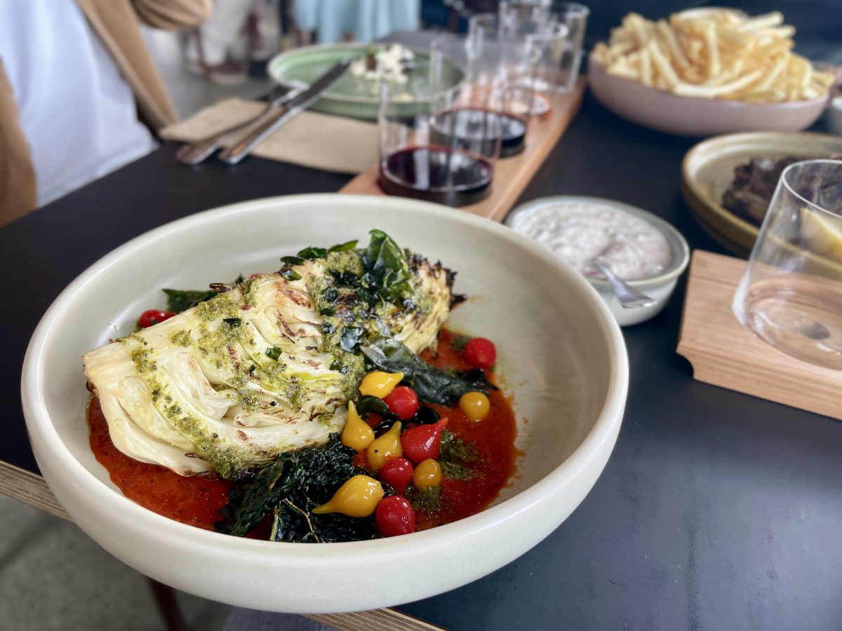A beautiful cabbage wedge with sauces.