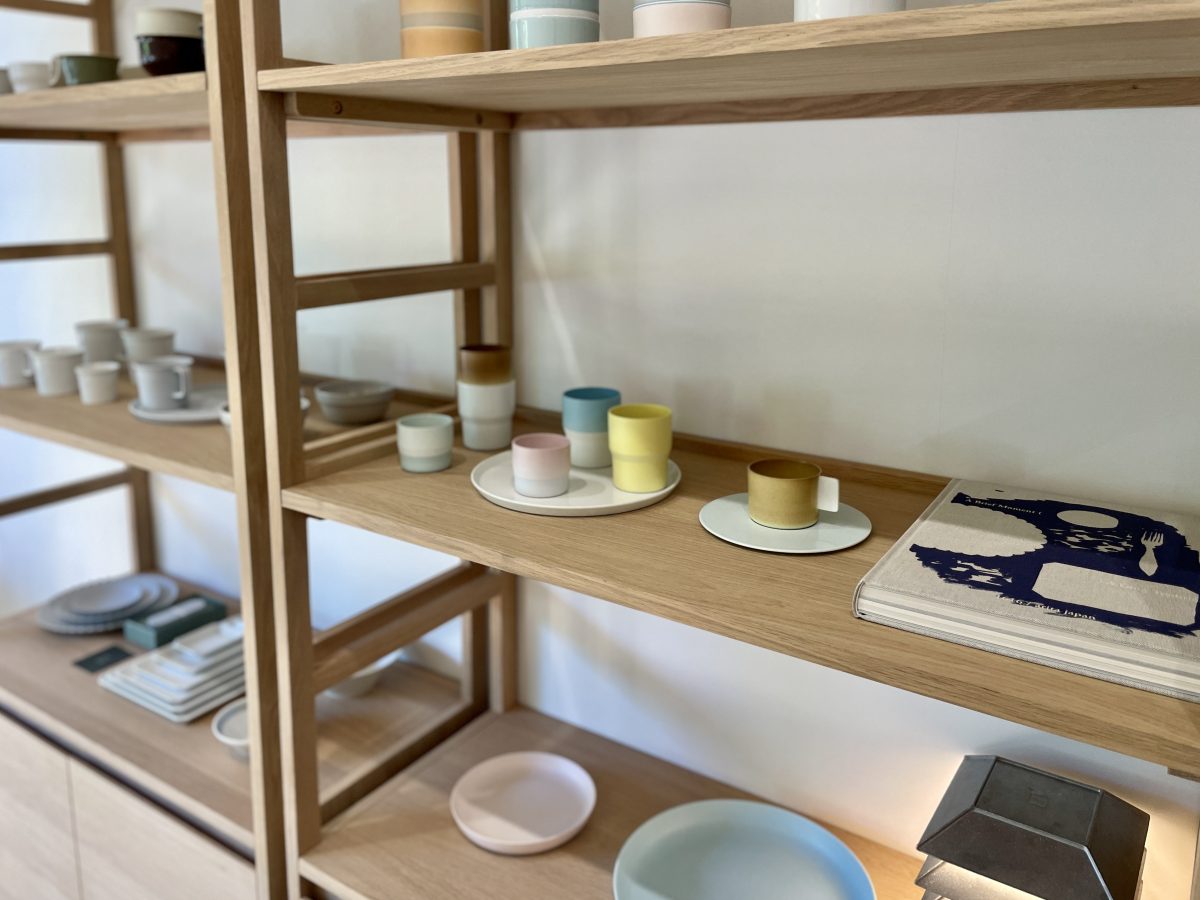 A shelf with simple but beautiful ceramics.