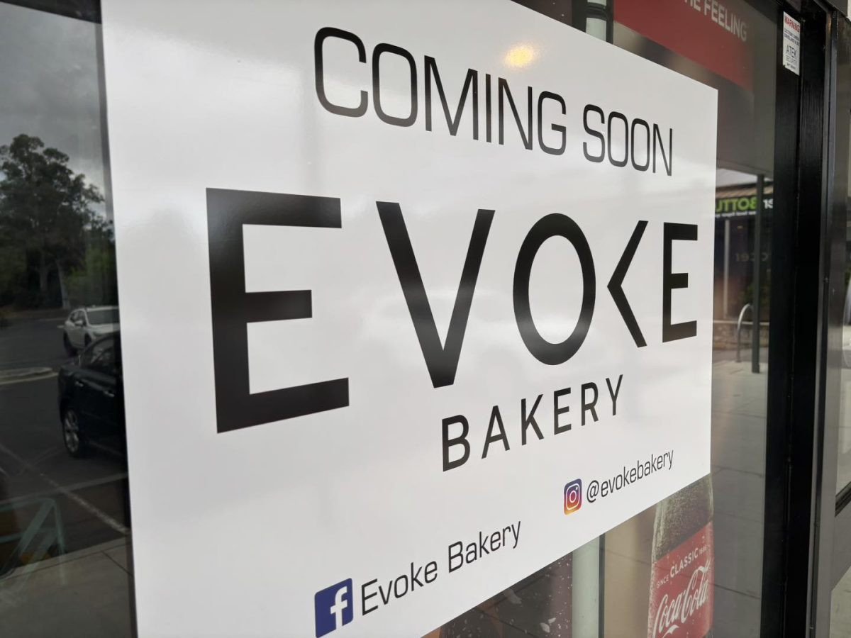 A sign reading ''COMING SOON Evoke Bakery'' on a shop window
