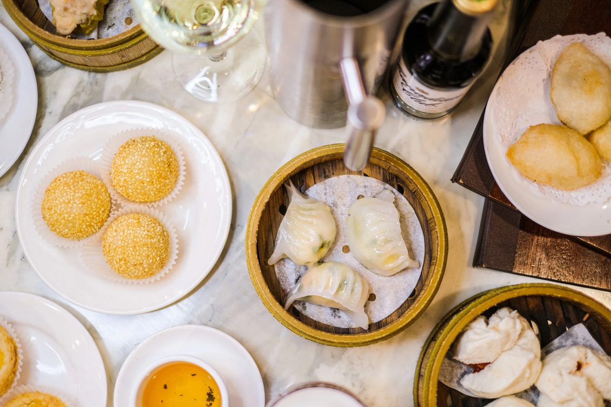 Dumpling baskets and plates on a table with Yum Cha dishes. 