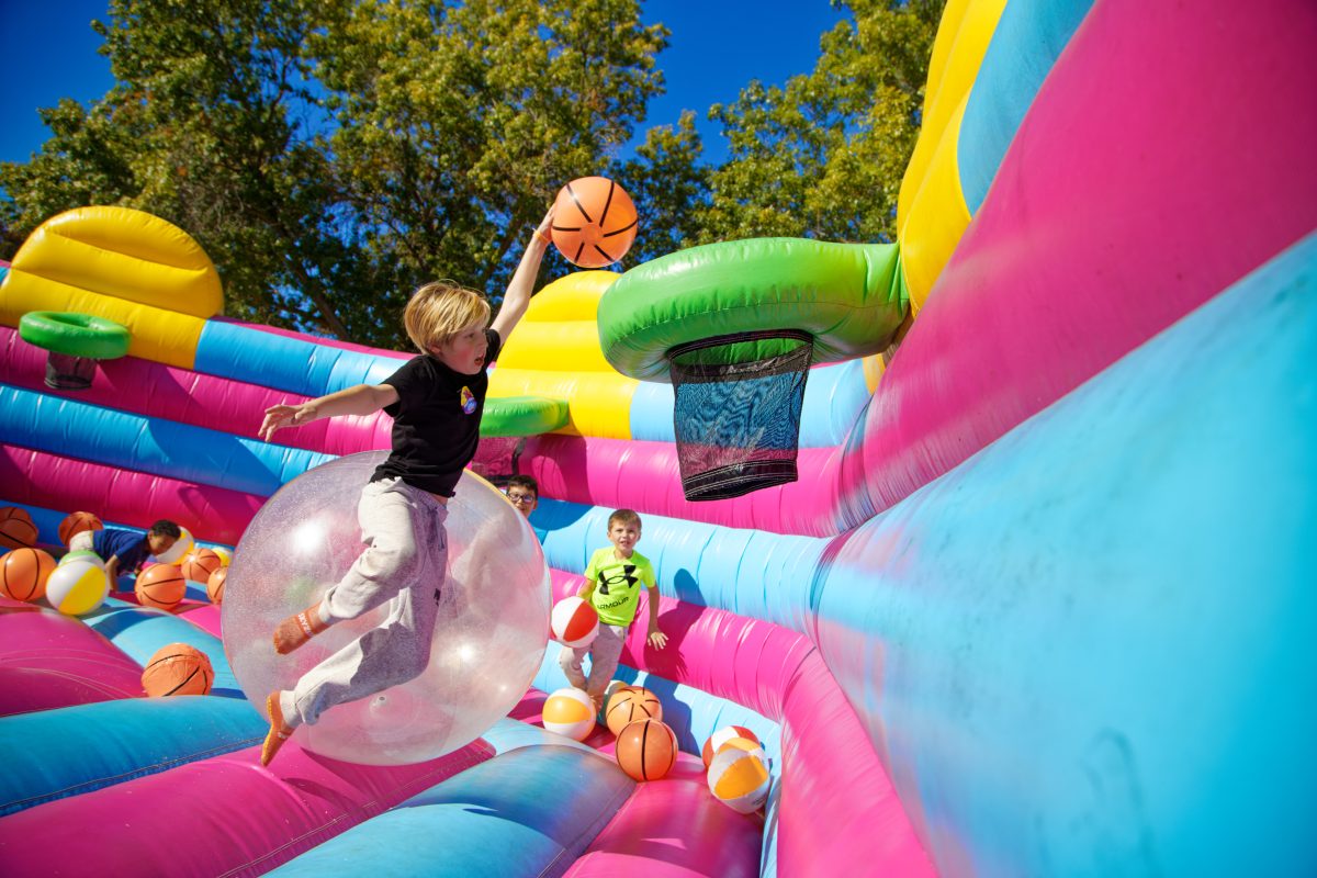 child using inflatable basketball course