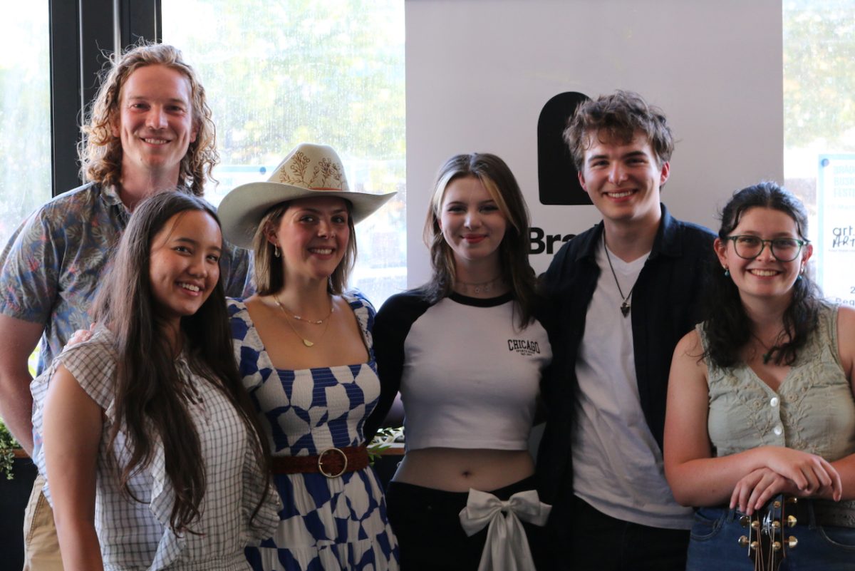 A group photo of young people smiling at the camera.