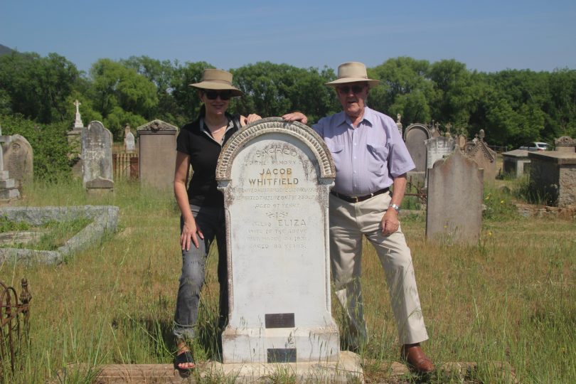 Kathryn Whitfield with her father Norman Whitfield at the grave of his great-great-grandfathe