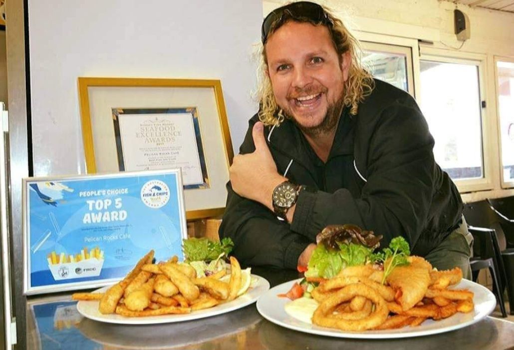 man with two plates of fish and chips