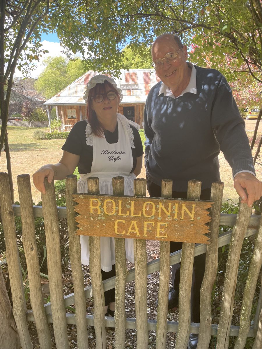 Woman and man behind fence of Rollonin cafe 