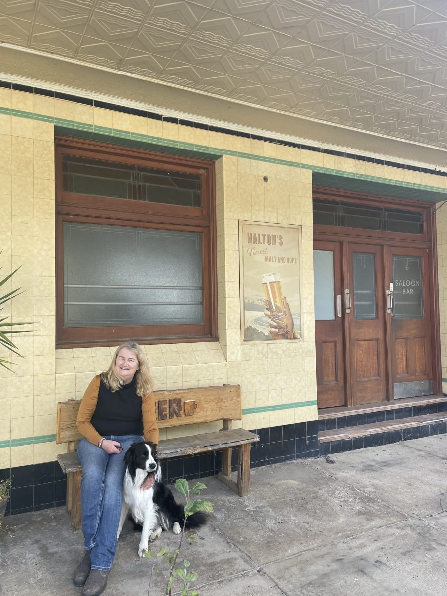 Woman with dog outside pub