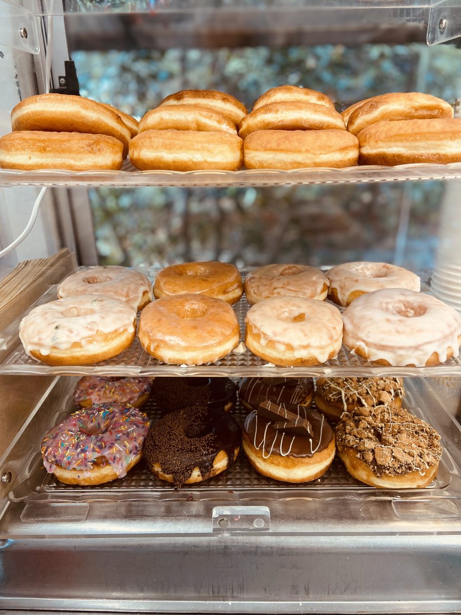 A shelf with different donut flavours